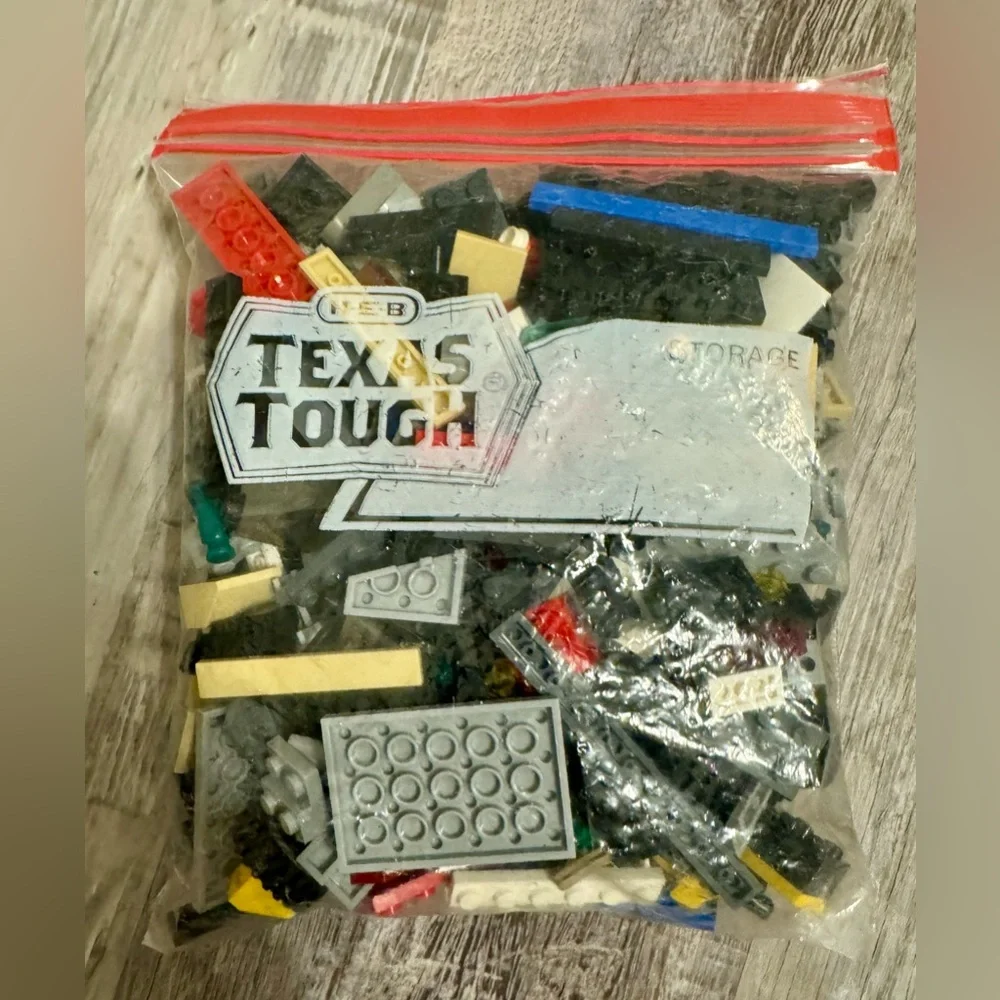 0.697 lbs. Net weight of small Lego bricks. Various parts and pieces. There are